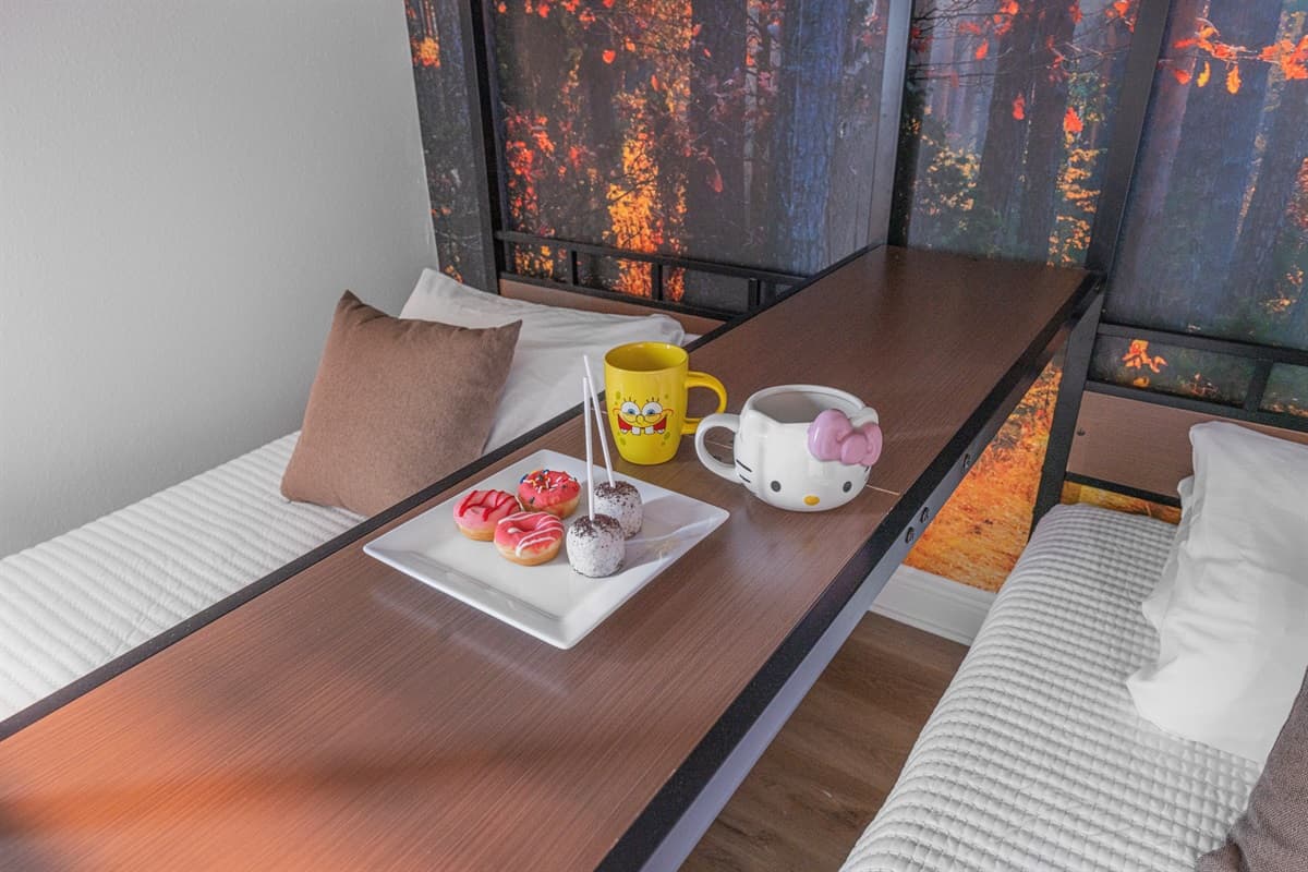 Close-up of bedside table with snacks and drinks, enhancing the home’s thoughtful hospitality touches.