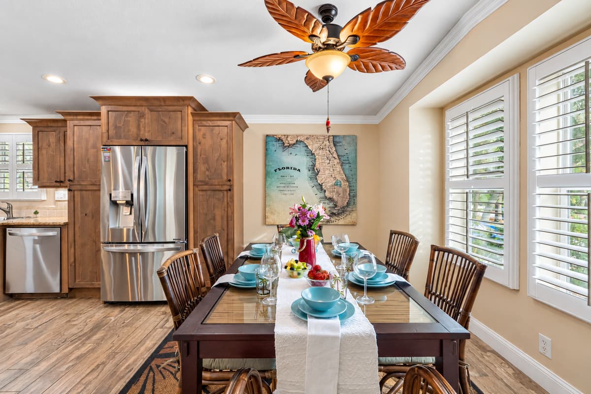 A stunning bay window fills the space with soft Florida sunshine, creating a warm mealtime atmosphere.