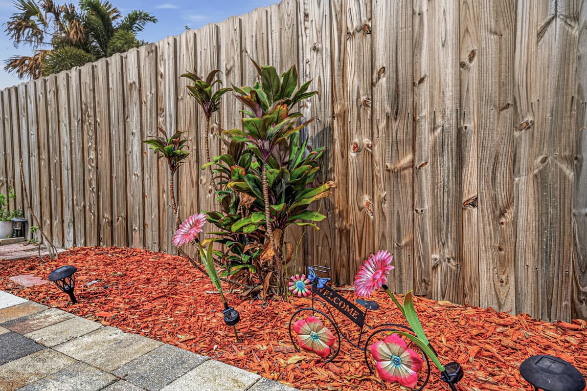 Thoughtfully maintained tropical landscaping enhances the privacy and charm of the outdoor space.