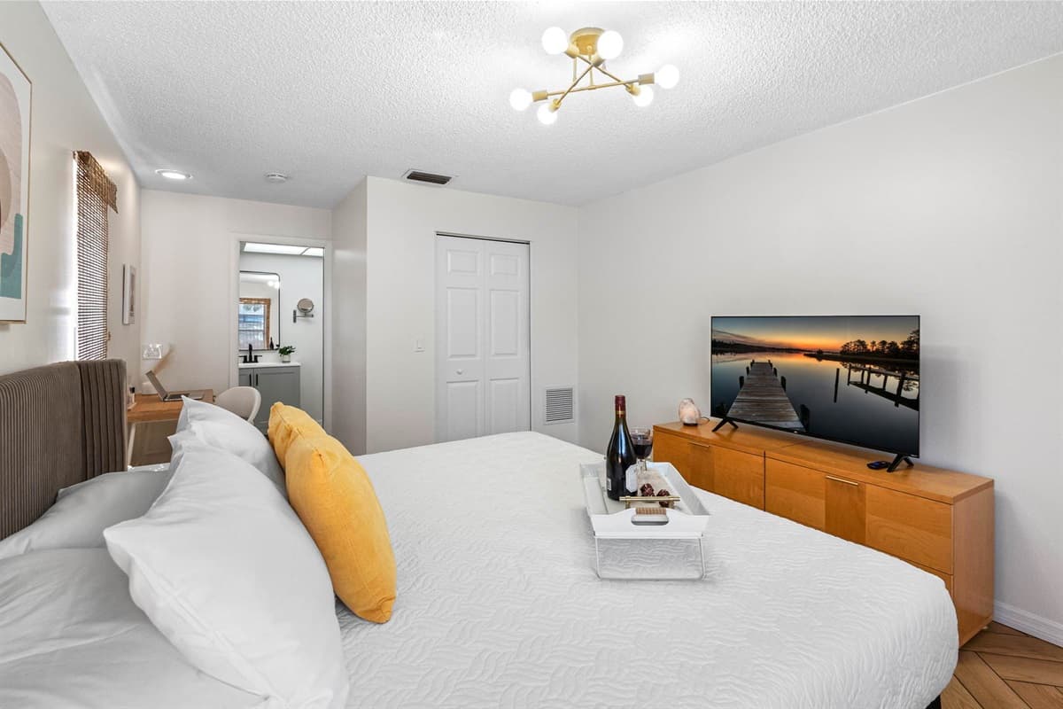 Modern, bright, and peaceful—this bedroom blends neutral tones with bold pops of color.