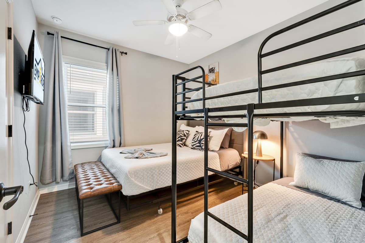 At the heart of this thoughtfully designed space is a sumptuous queen-size bed, adorned with soft linens and an array of pillows, beckoning you to a night of tranquil repose.