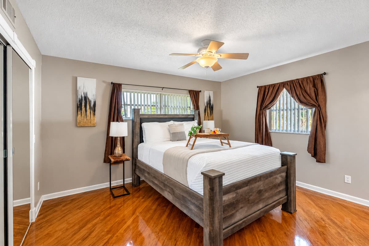 Complete with matching nightstands, dresser, and built-in lighting on the headboard, this bedroom combines function with comfort.