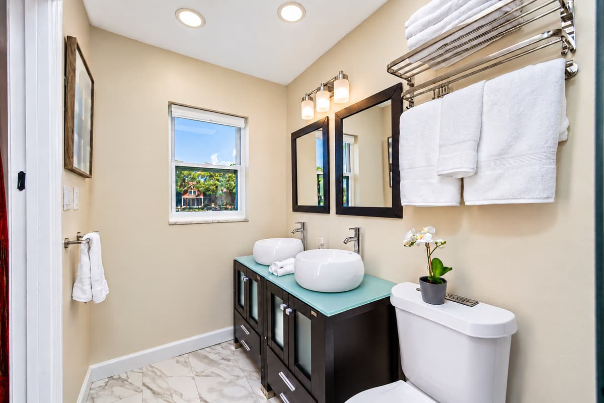 Beautiful bathroom equipped with his and hers sink, toilet, and shower. Enjoy a relaxing bath after a long day of travel from your home to your home away from home. If you think this property is for you, send us an inquiry right away!
