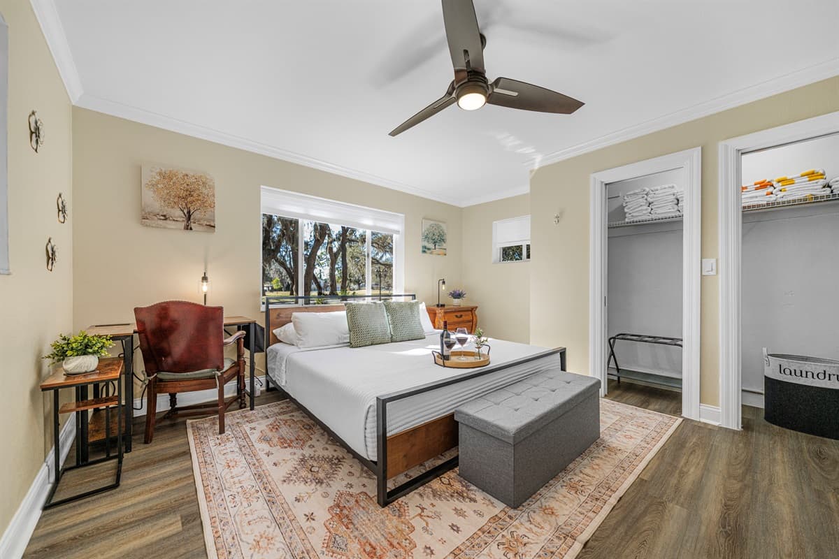 This serene bedroom features a comfortable king-size bed, soft linens, and calming décor—perfect for restful nights and relaxed mornings.