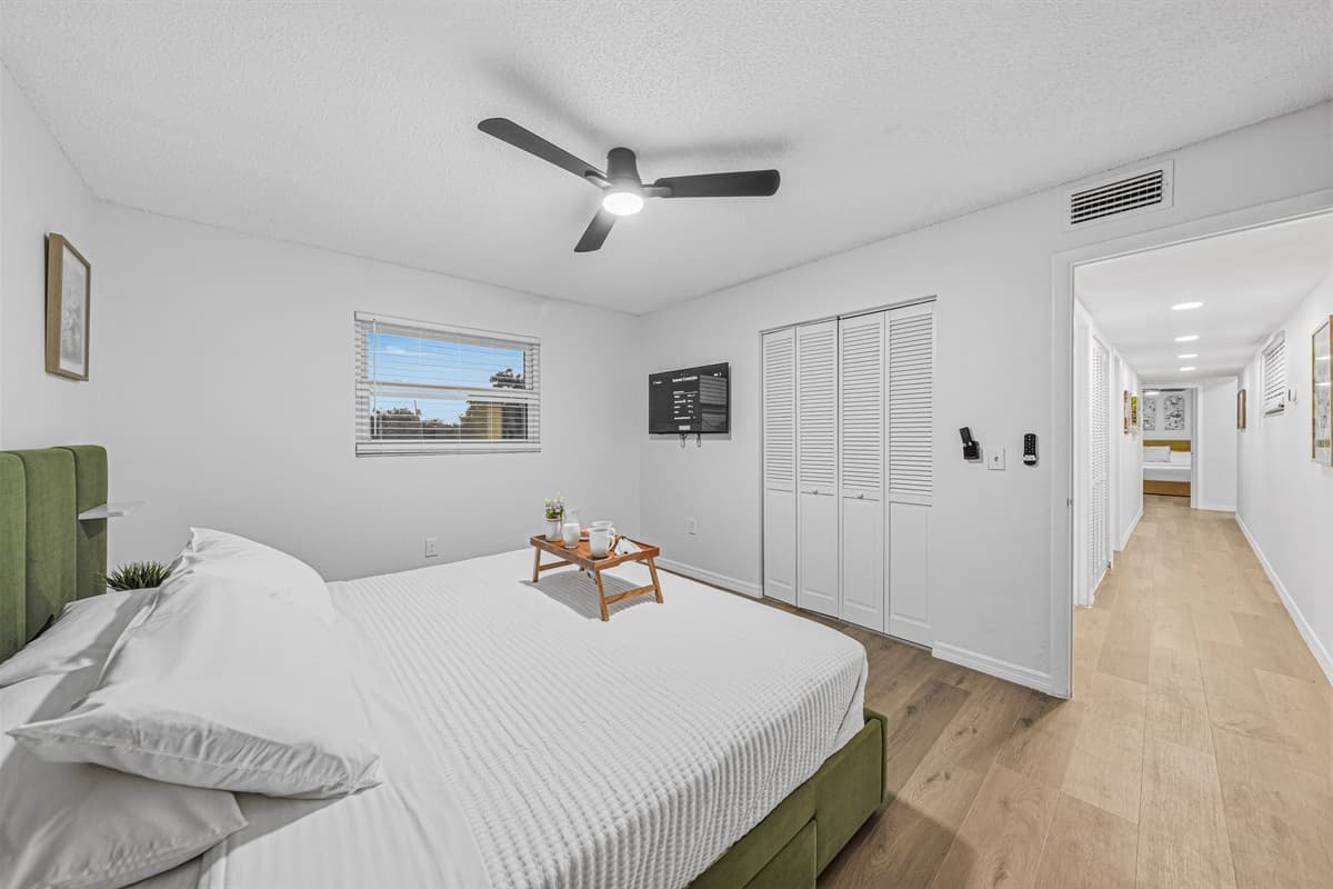 Spacious king bedroom with simple, modern styling and plenty of room to unwind after a long day 