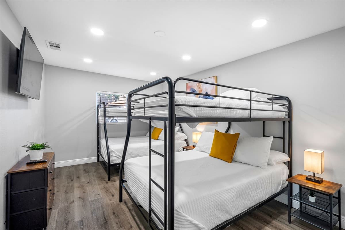 Natural tones, soft lighting, and cozy beds make this the perfect shared retreat.