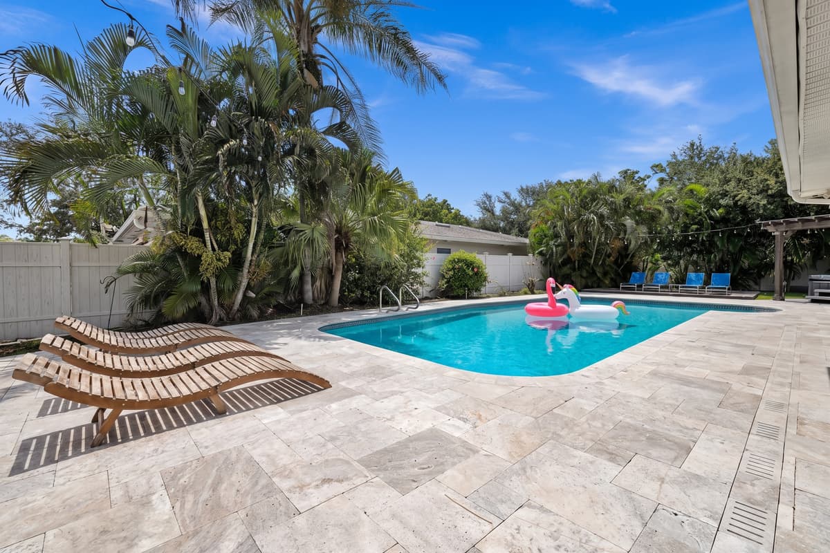 A flamingo float drifts across the pool while loungers sit ready poolside, an easy scene to picture yourself in