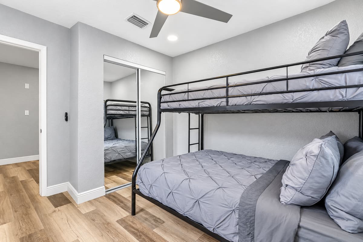 Twin-over-full for flexible sleeping. A full bed on the bottom, a twin up top, and a mirrored closet. Great for siblings or a parent with a little one, with room to unpack for the week.