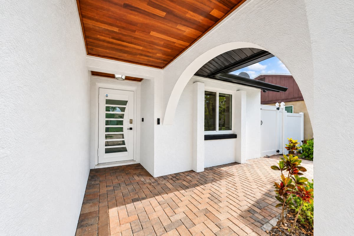 Welcoming covered front entry featuring elegant architectural details and a charming arrival experience for guests.