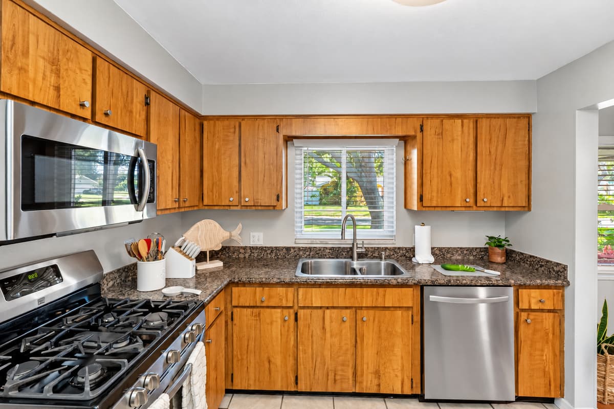 Brew your morning coffee and enjoy the sunrise with this serene window-side sink setup.