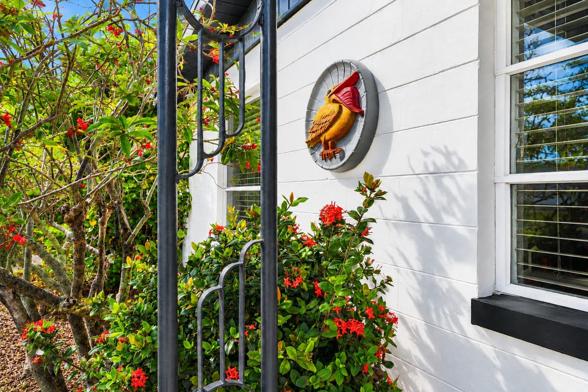 Beautiful landscaped entryway featuring colorful flowers and welcoming décor accents.