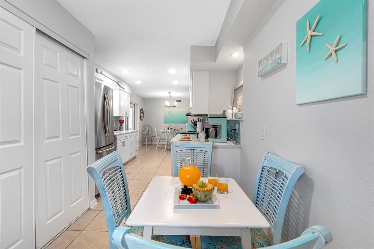 A second dining area offers a cozy four-seater dining table, ideal for more intimate meals or casual dining.