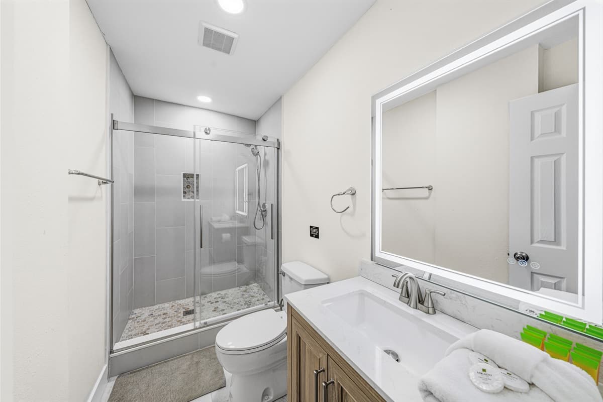 Clean, modern bathroom with a large vanity, bright lighting, and premium finishes.