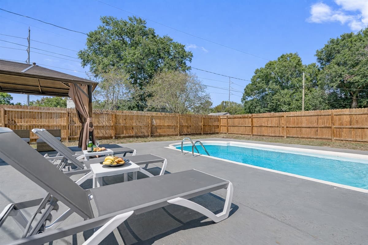 Lounge chairs are dotted near the pool, beckoning you to recline in style and soak up the rays.