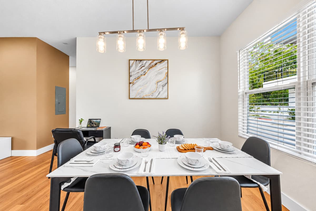 Spacious dining area with stylish lighting and seating for the whole group.