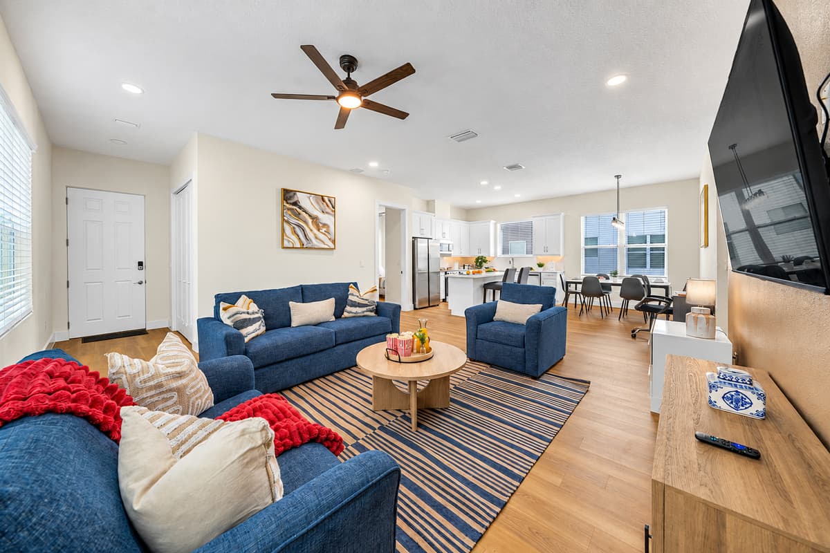 Spacious open-concept living area connecting seamlessly to dining and kitchen spaces.