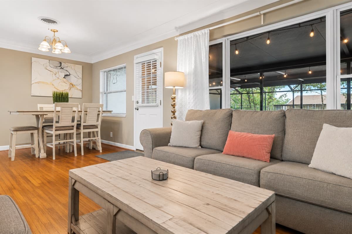 Bright and welcoming living room with cozy seating and an open connection to the dining area.