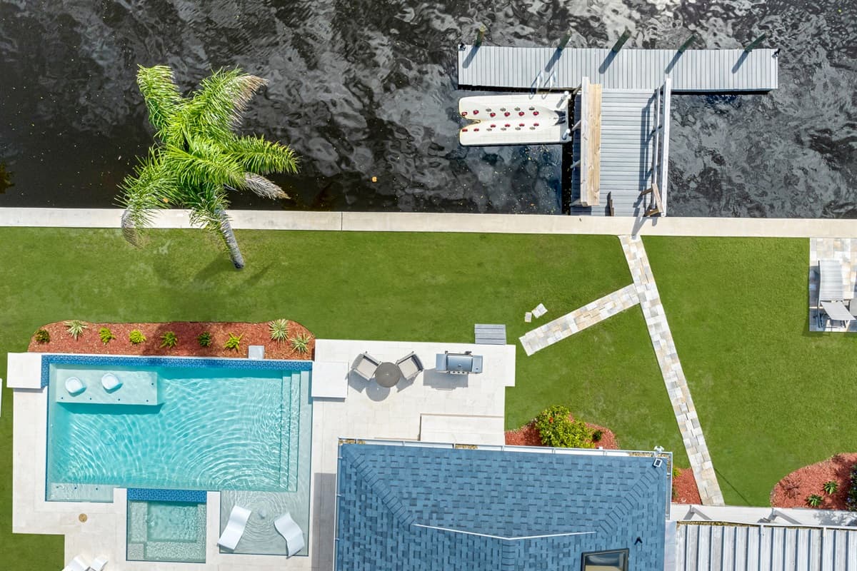 Top view of our immaculate property showcasing the stunning heated pool and lounge area at the back of the property. Love what you see? Ask us questions and send us an inquiry as soon as possible!