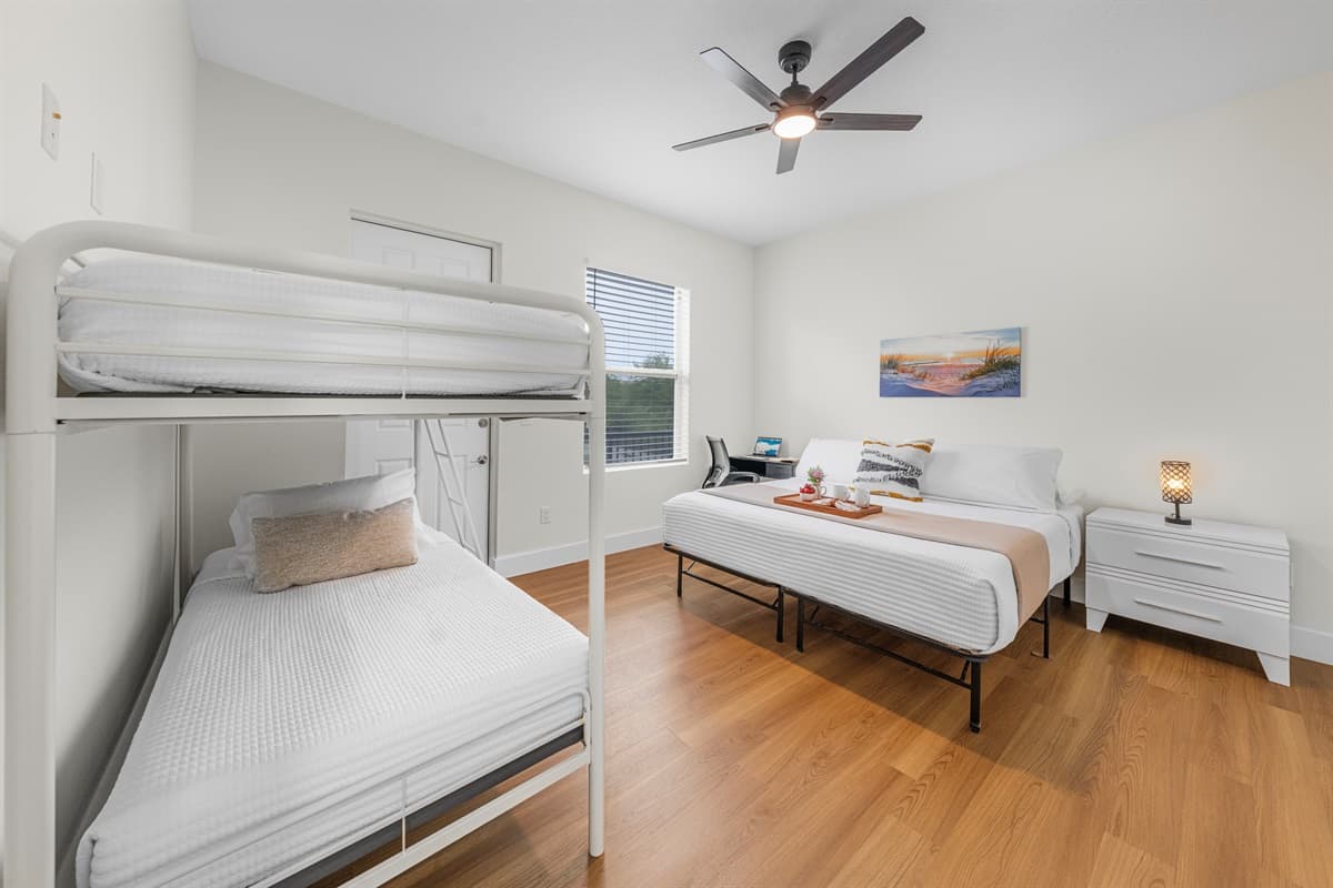 Versatile sleeping area with bunk beds and queen bed for flexible arrangements.
