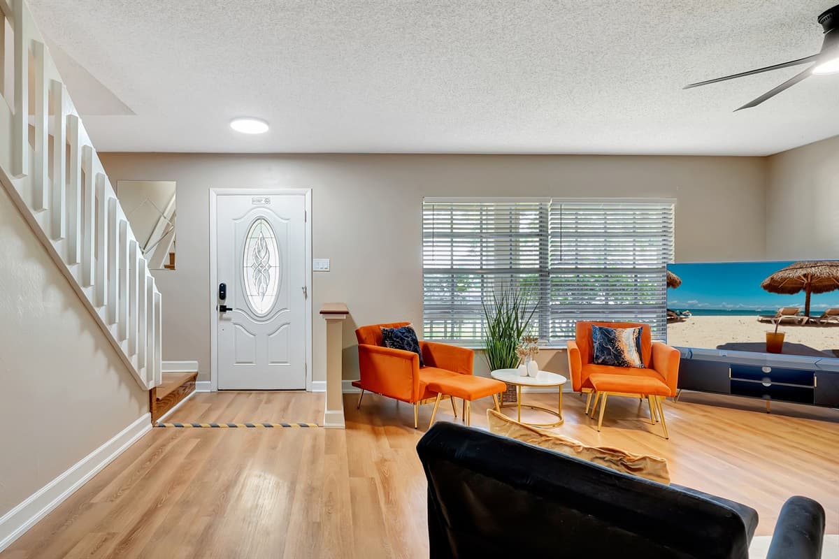 As you enter, the natural light dances across the light wooden floors, creating a warm and welcoming ambiance.