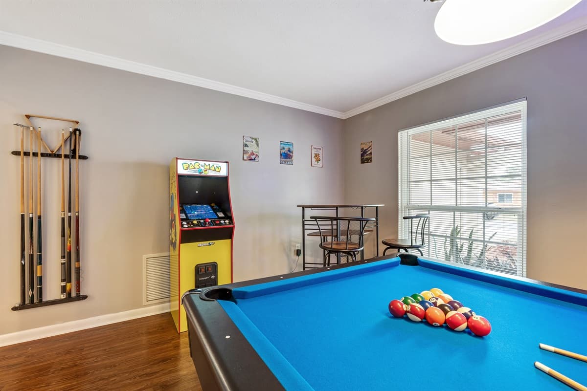 Adjacent to the PAC MAN marvel is a meticulously crafted pool table, promising hours of spirited camaraderie and skillful play.