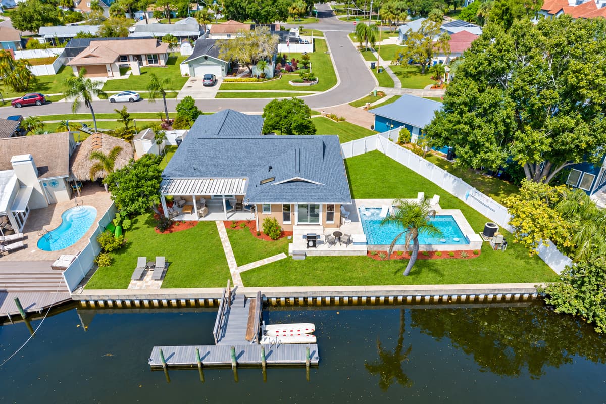 Aerial view of our beautiful property and the stunning view of the lake. Enjoy the view outside showcasing beautiful properties in the area. If you like this property, please send us an inquiry right away!