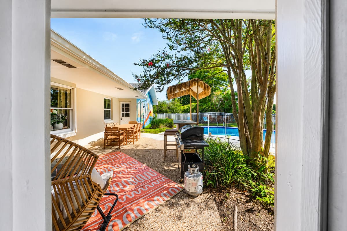 Open the door and the grill, the shade, and the pool are all right there. No stairs, no walk, no waiting.
