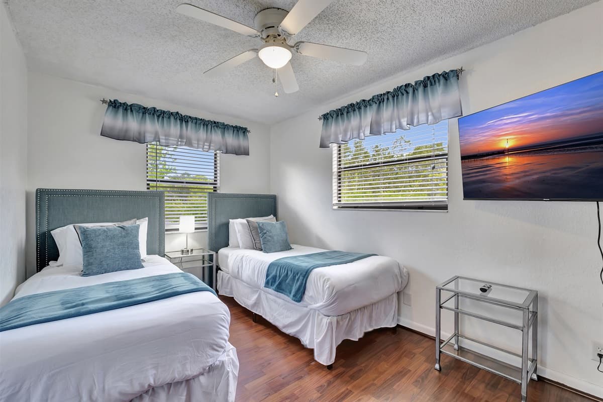 The twin beds are outfitted with soft, high-quality linens and plush pillows, ensuring a restful and comfortable night's sleep.