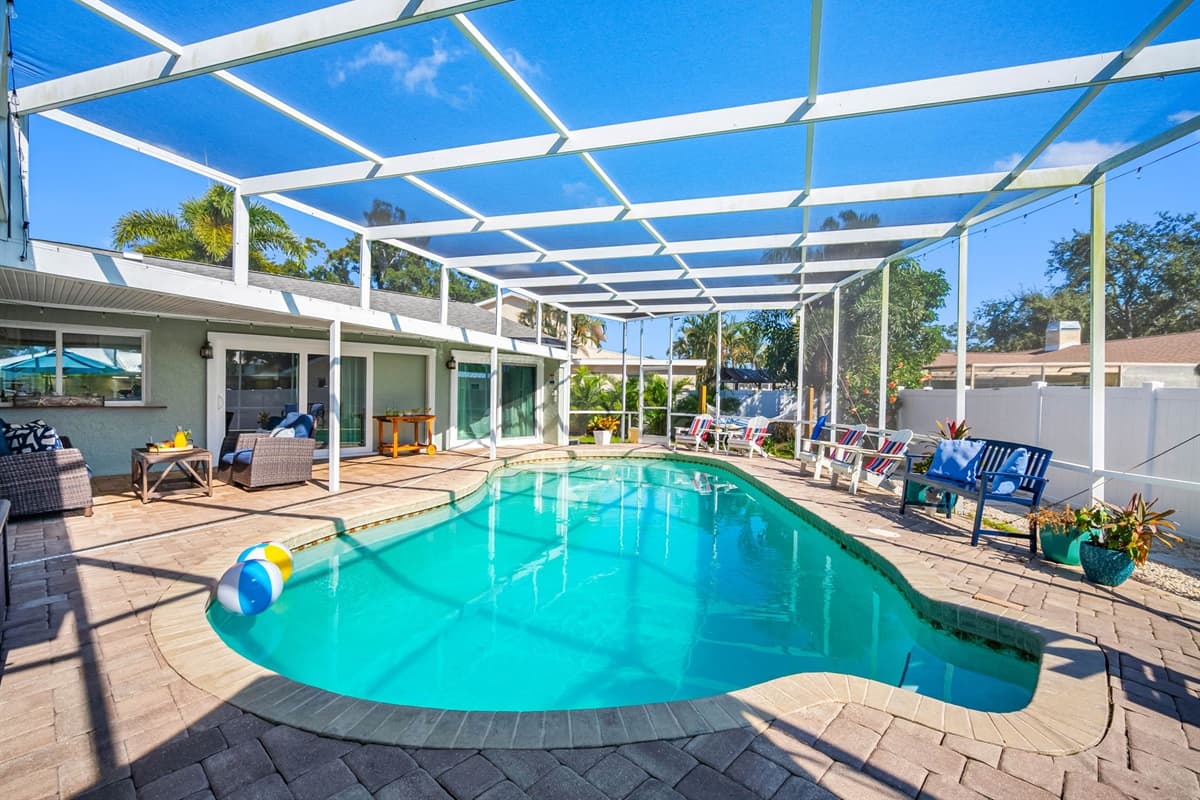 Stretch out on the loungers, take a dip in the crystal-clear pool, or enjoy dinner al fresco under the screened lanai — this backyard retreat has it all.