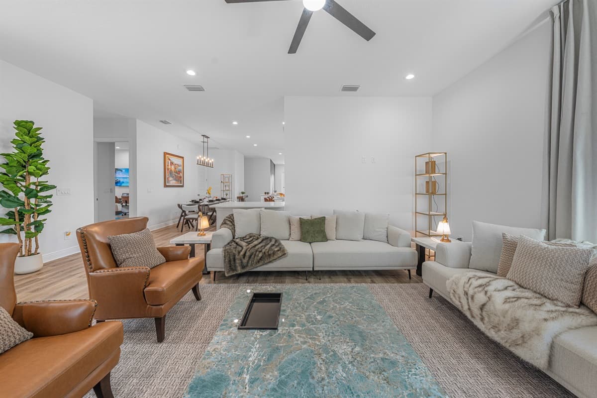 Another perspective of the open living space showing seamless flow between lounging and dining areas.