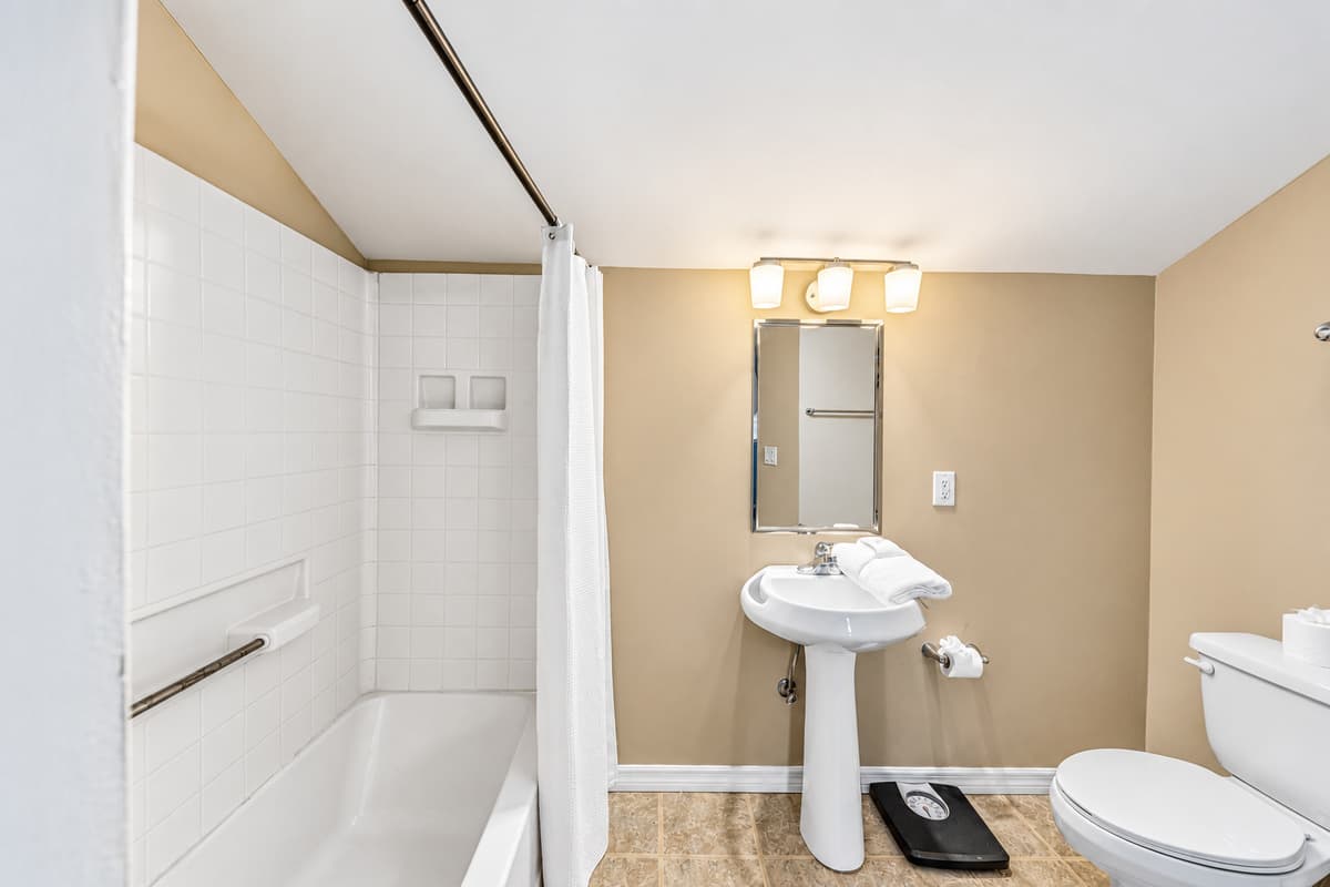 Additional full bathroom with simple, clean design and essential amenities.