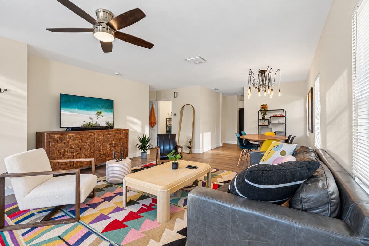Modern living room equipped with a large flat-screen smart TV where you can chill and catch up on your favorite TV series. If you have any questions at all, please send us an inquiry today!