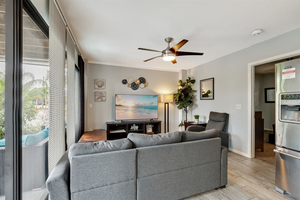 Welcome to our inviting living room, designed with your comfort in mind. Our plush, cozy gray sofas will beckon you to sink in and unwind after a long day of exploring.