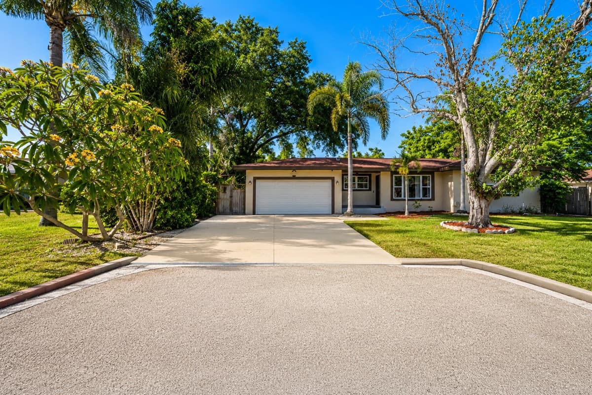 Wide front exterior shot showcasing the home’s quiet residential setting and spacious parking area.