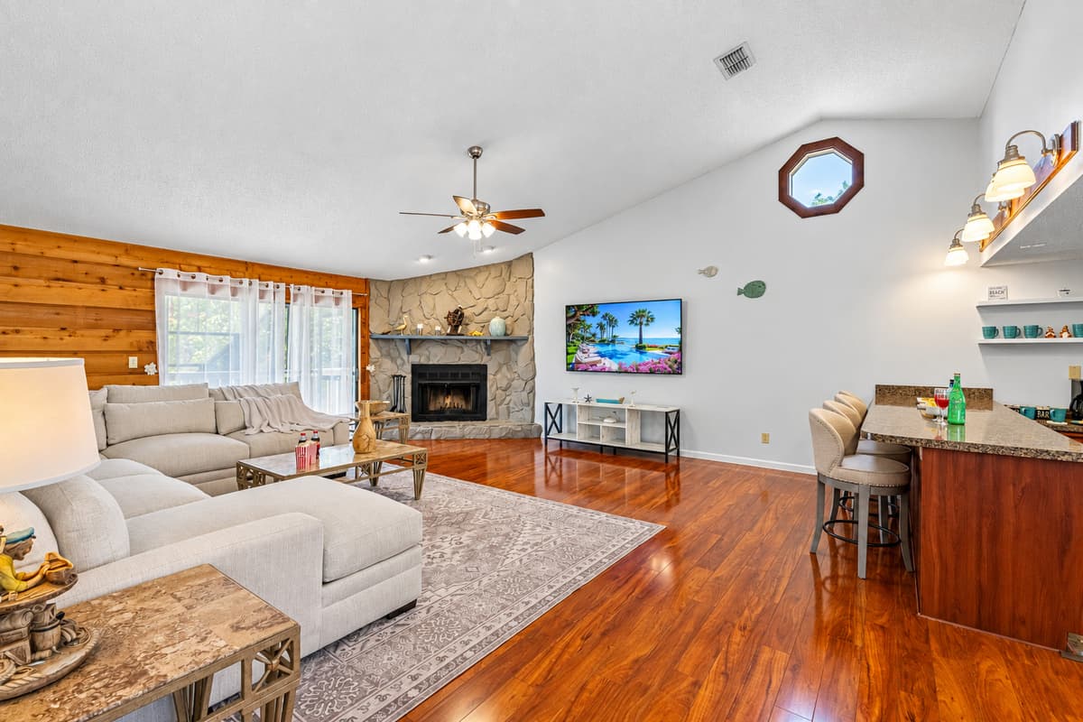 With rich hardwood floors, soaring ceilings, and a large, plush sectional, this is the kind of space that invites guests to kick off their shoes, sink in, and stay a while.