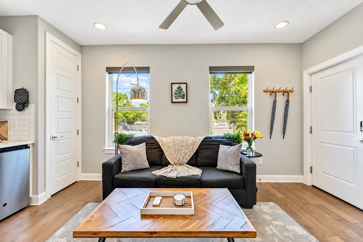 You'll be greeted by the warmth of a comfortable three-seater couch, beckoning you to sink in and make yourself at home.