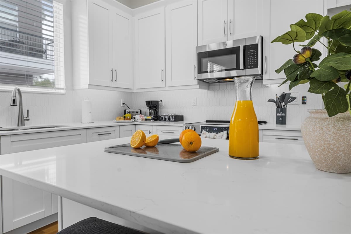 Clean and modern kitchen design with natural light and stylish finishes throughout.