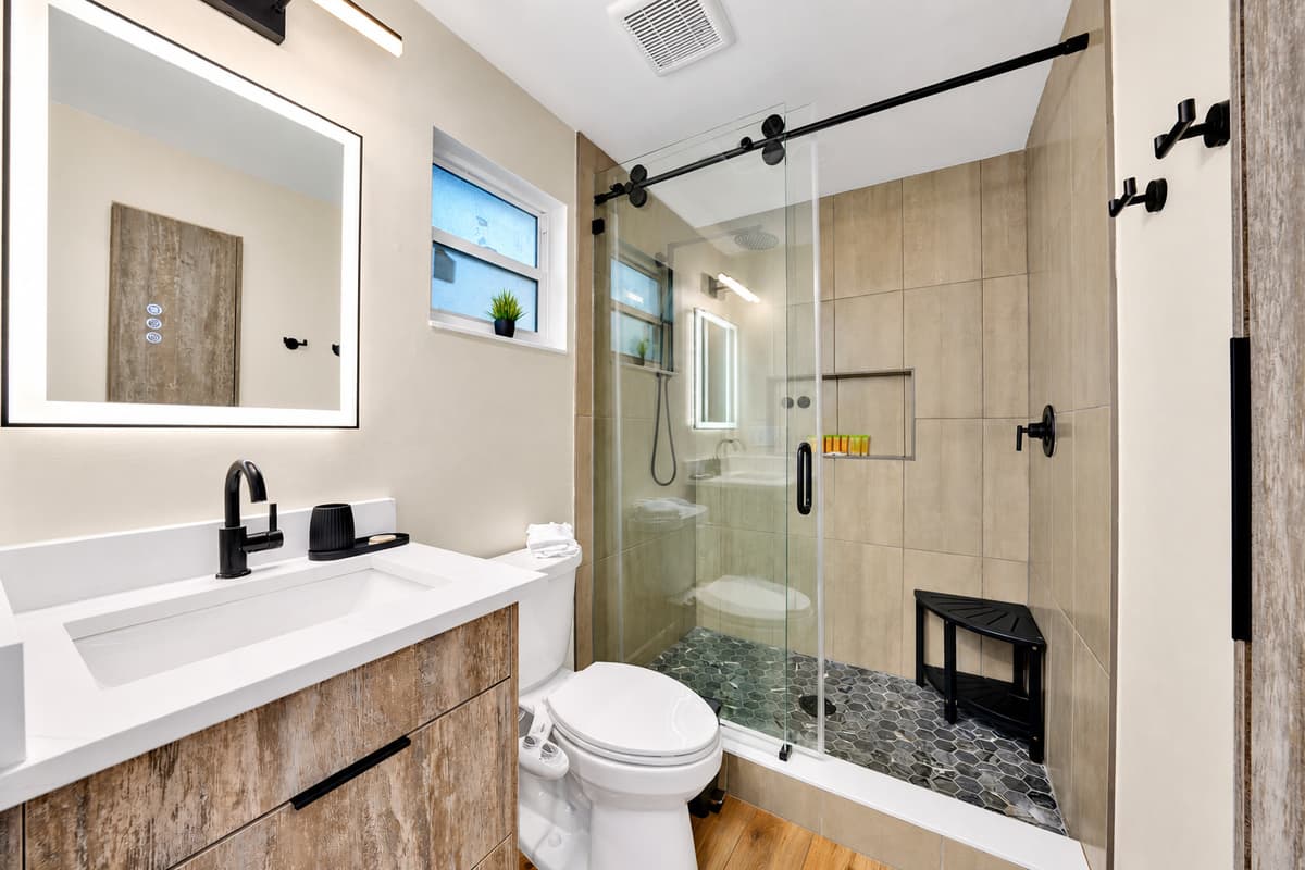 Seven and a half bathrooms means no waiting, ever. Rain-style shower behind glass, counter space for two people's things, and light that actually works for getting ready.