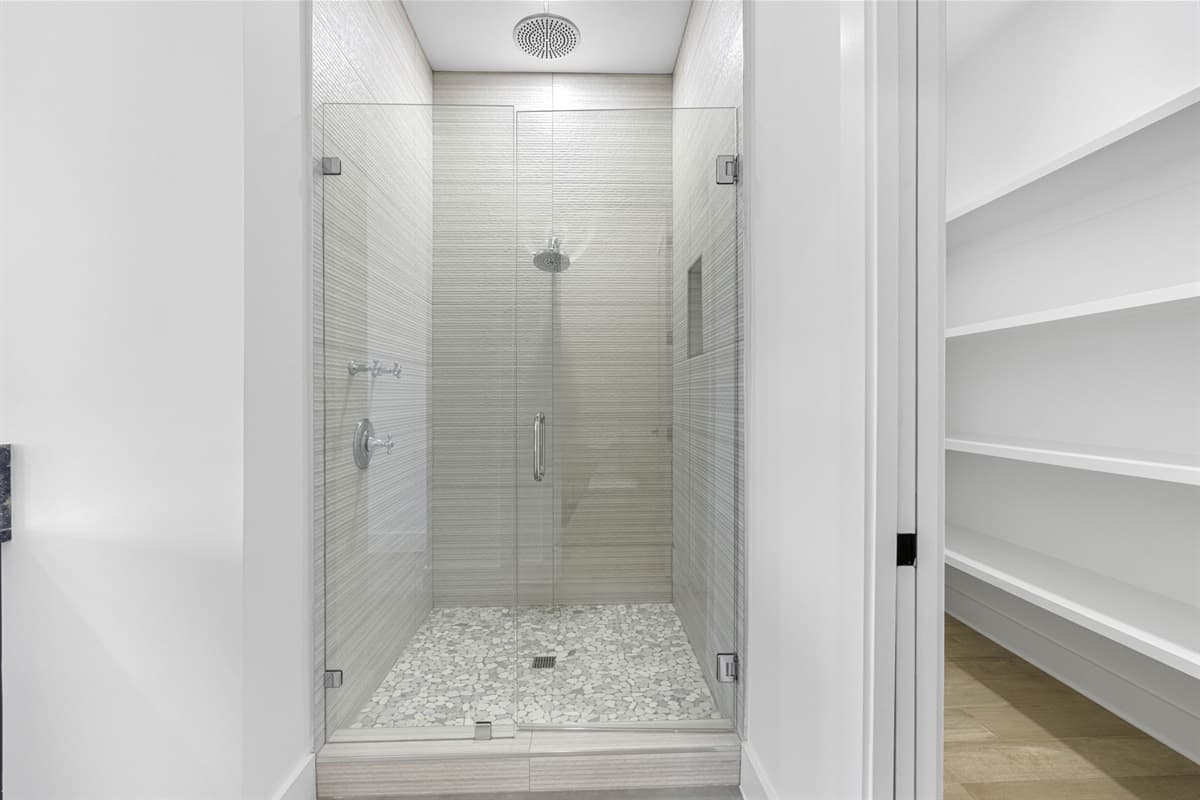 The bathroom’s minimalist design exudes sophistication and comfort, making it an inviting space for your daily routines.