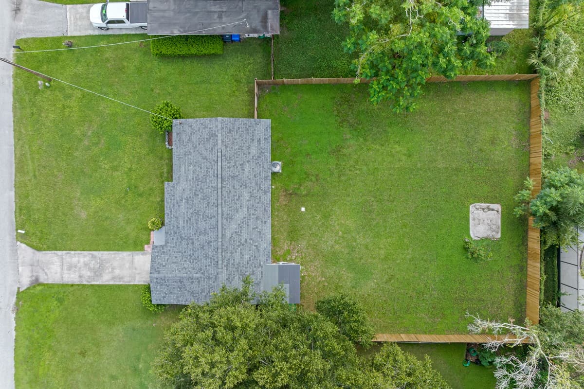 Top view of our beatiful property showcasing the spacious fully fenced backyard, the well maintained frontyard and the driveway! Book with us now! Love what you see? Ask us questions and send us an inquiry as soon as possible!