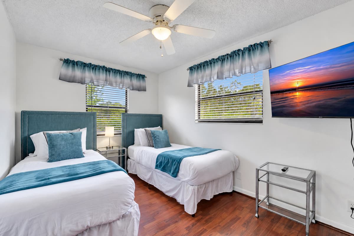 The twin beds are outfitted with soft, high-quality linens and plush pillows, ensuring a restful and comfortable night's sleep.