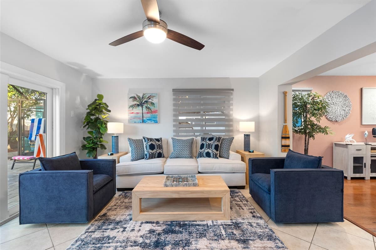 This inviting space is designed to be a cozy retreat for guests, featuring a plush sofa and  swivel chairs that provides ample seating for everyone.