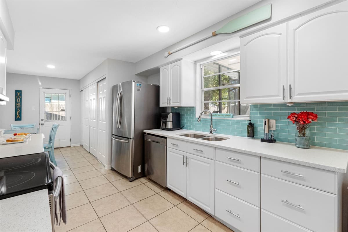 The heart of the home, the kitchen, is a bright and inviting space, fully stocked with all the essential appliances you'll need to create delicious meals throughout your stay.