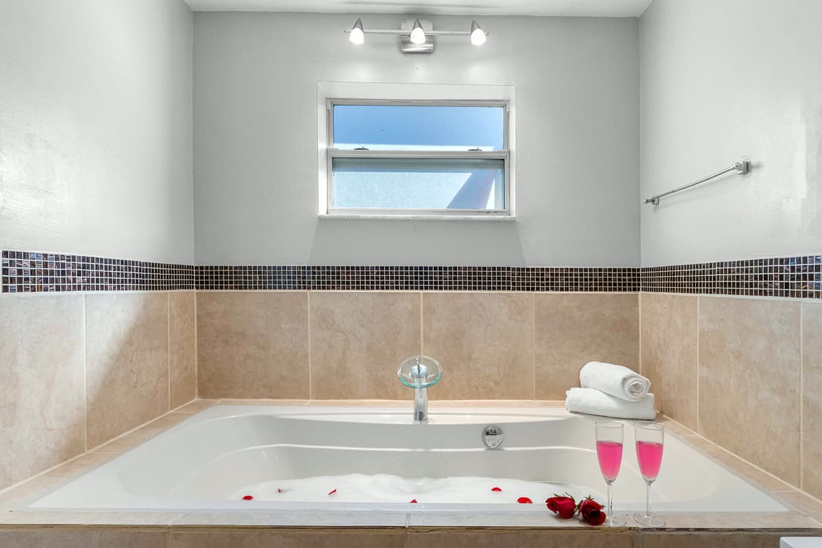 Relax and recharge in the ensuite’s deep tub — the perfect post-beach treat.