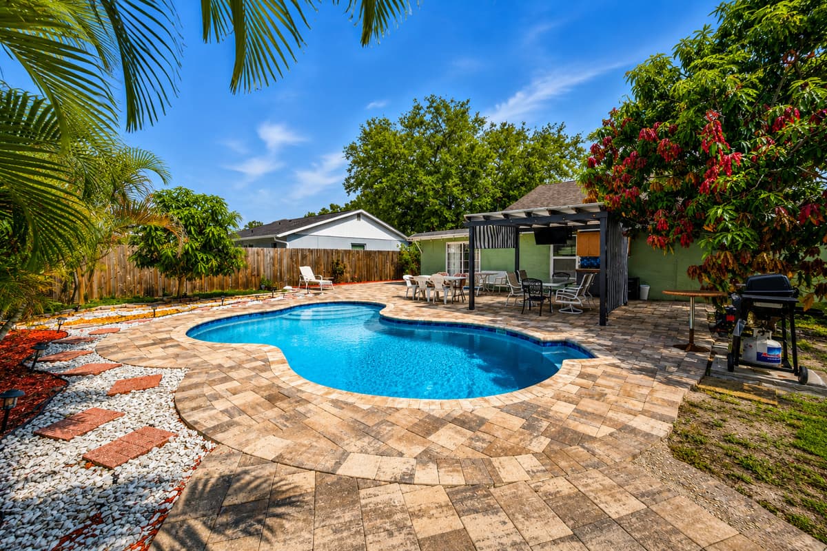 Enjoy resort-style outdoor living with a private pool, tropical landscaping, and spacious patio areas.