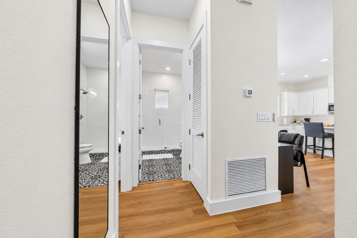 Central hallway links the bedrooms, bathrooms, kitchen, and living area.