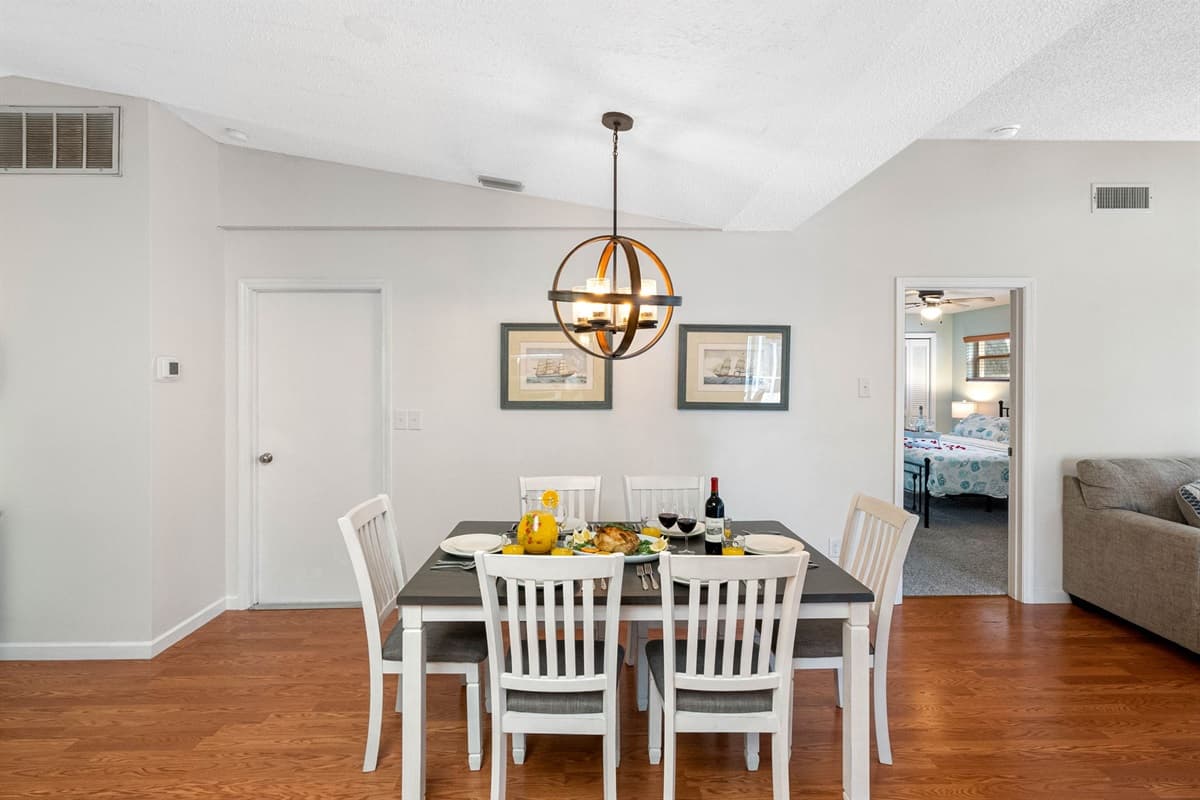 Adjacent to the kitchen is a stylish 6-seater dining table, thoughtfully chosen to complement the kitchen's aesthetic