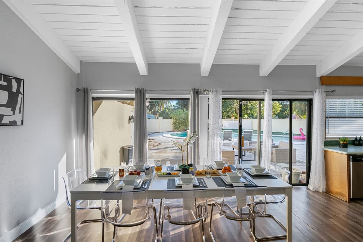 Enjoy meals with a beautiful view of the pool and patio through wide sliding glass doors.