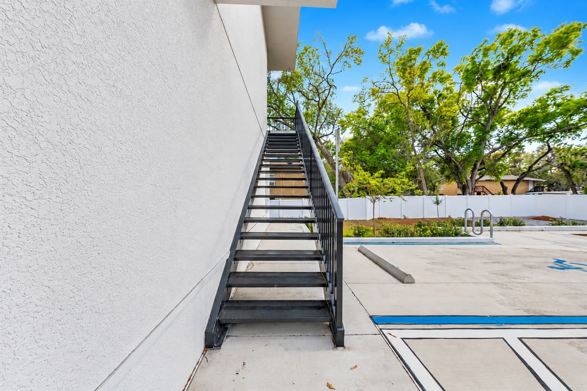 Your stairs lead to your door. That's it. An exterior staircase climbs straight to your 2nd-floor private entrance. No shared lobbies, no elevators, no long hallways: just park, climb, unlock, and you're home.