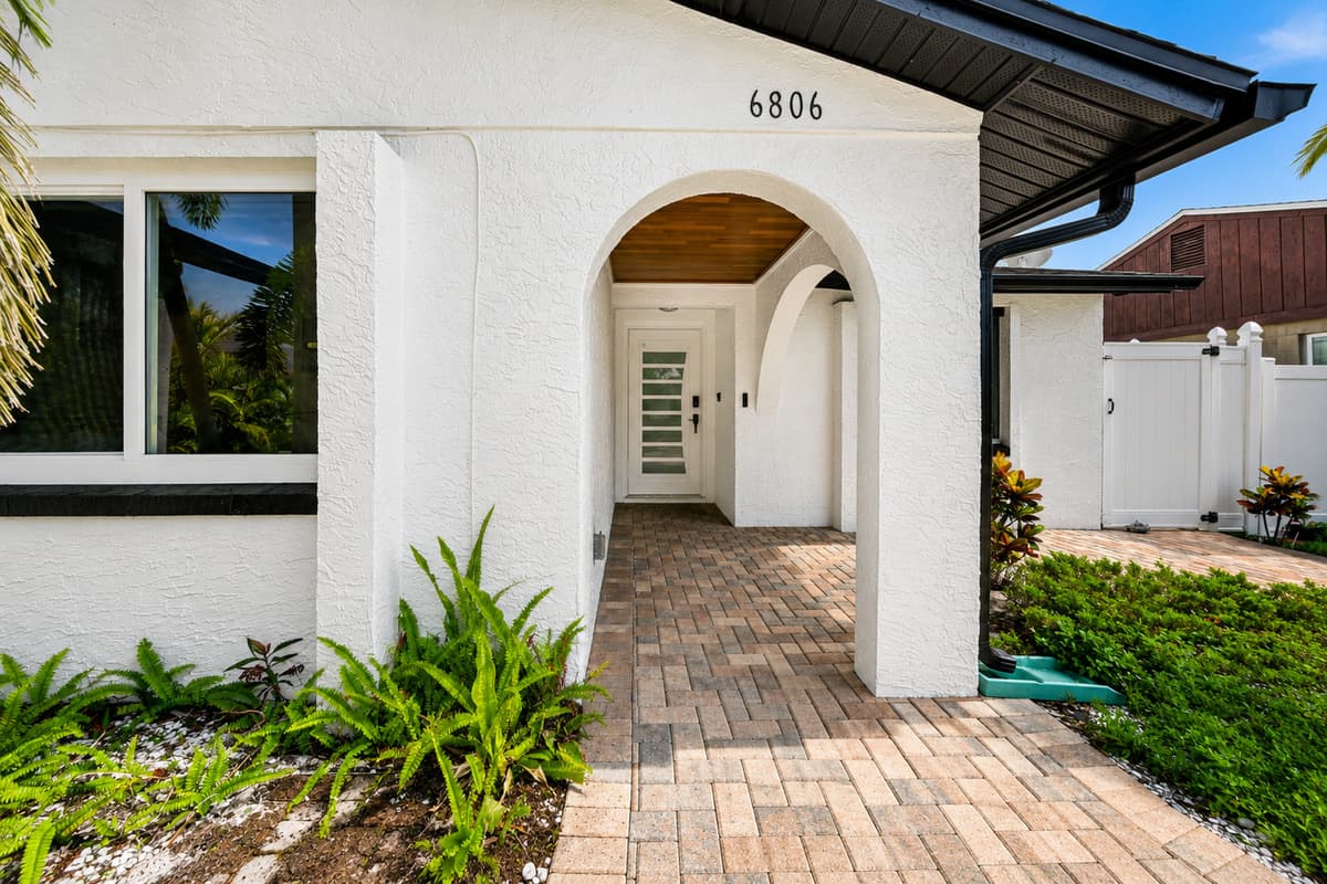 Beautiful front entrance with a covered walkway and stylish curb appeal, creating a warm first impression upon arrival.